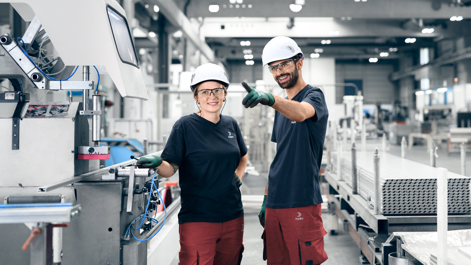 a man and woman wearing hard hats
