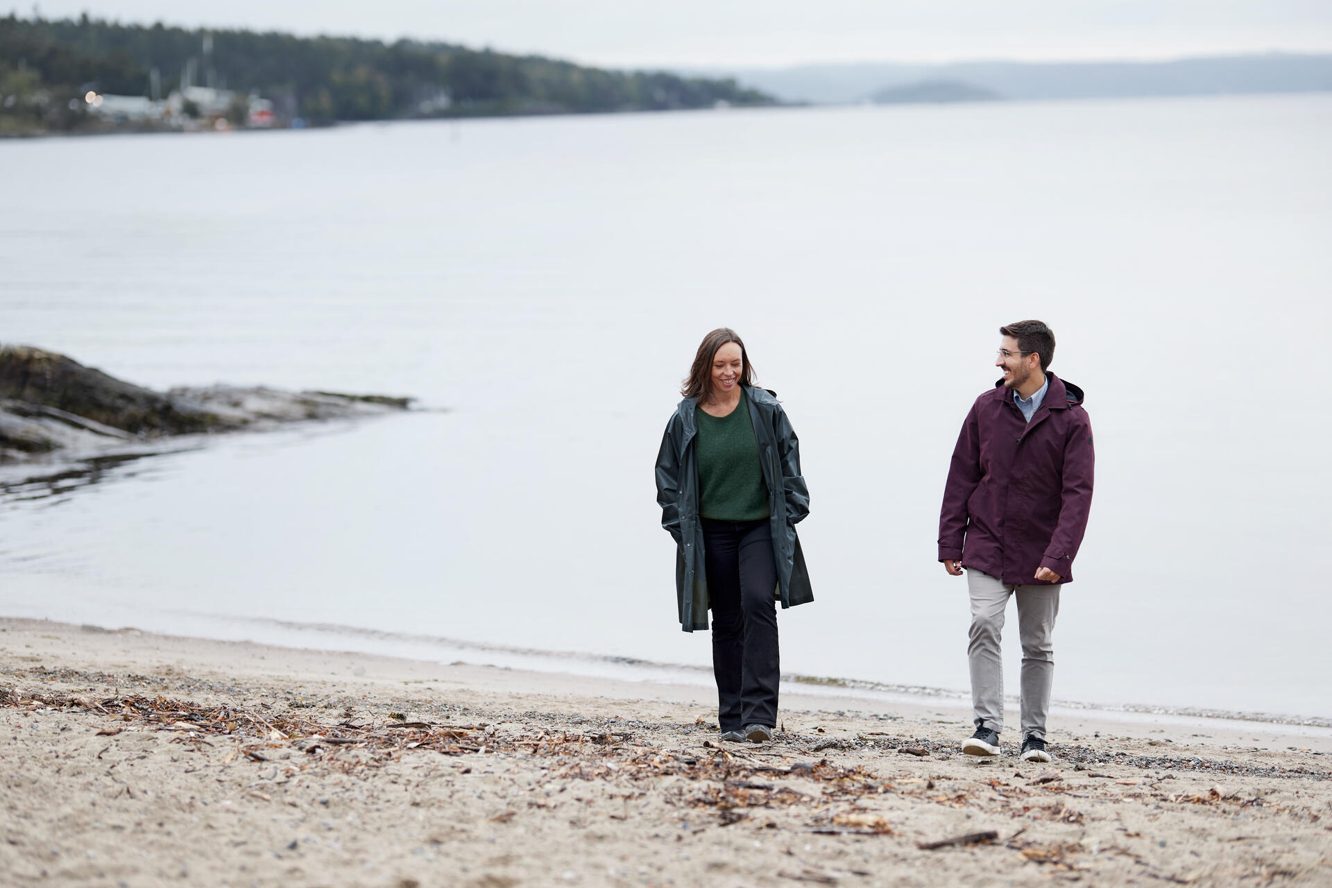 a man and woman standing on a beach