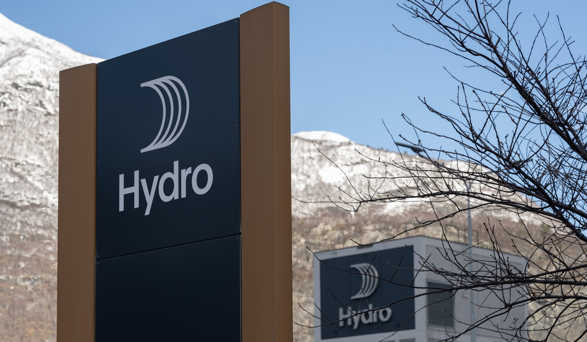 a sign with a building in the background