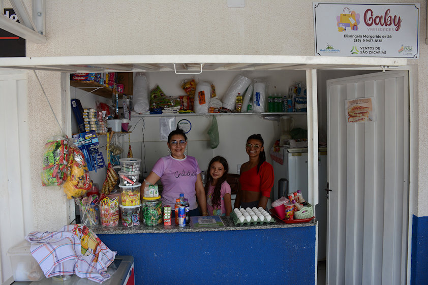 a group of people posing for a photo in a kitchen