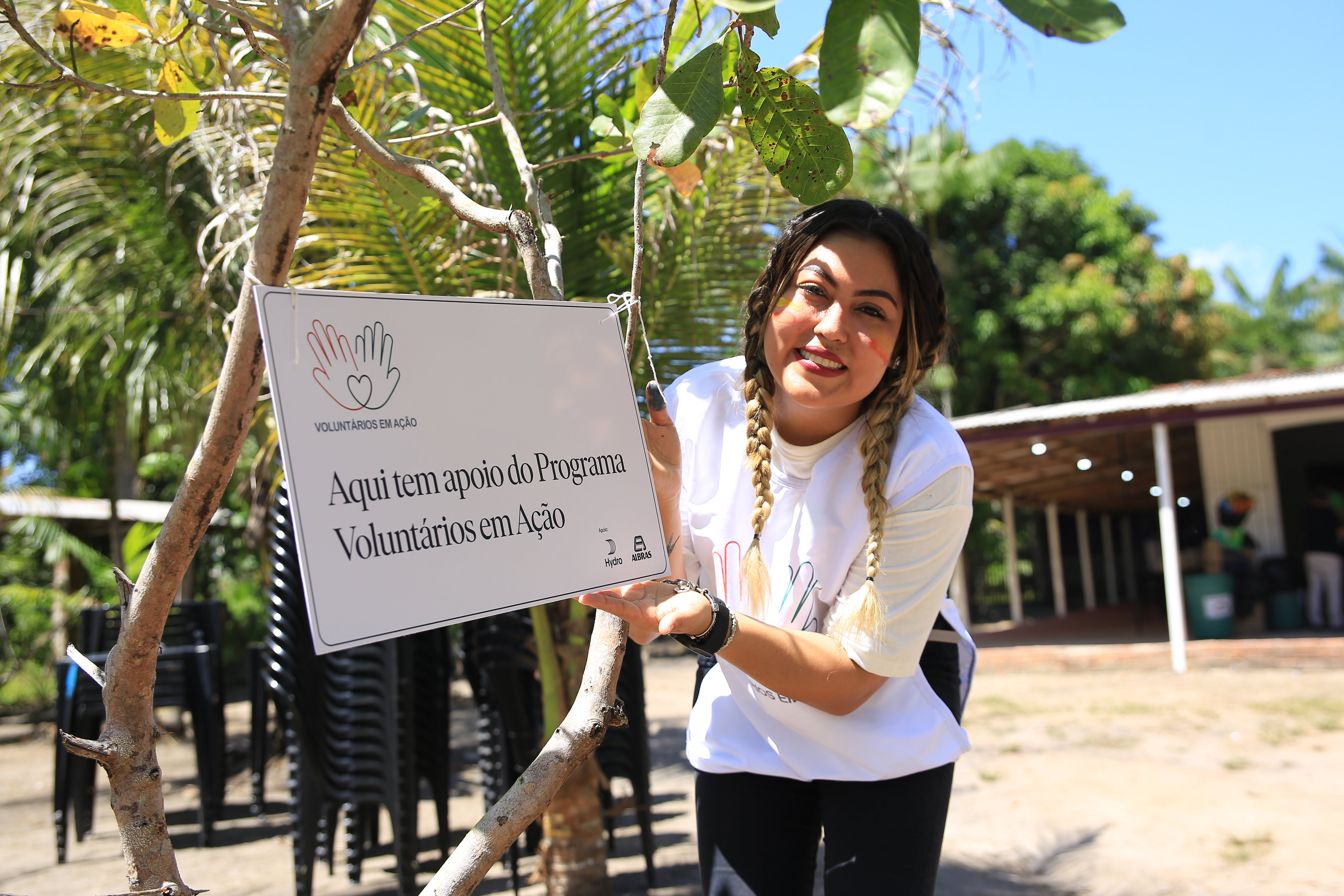 a woman holding a sign