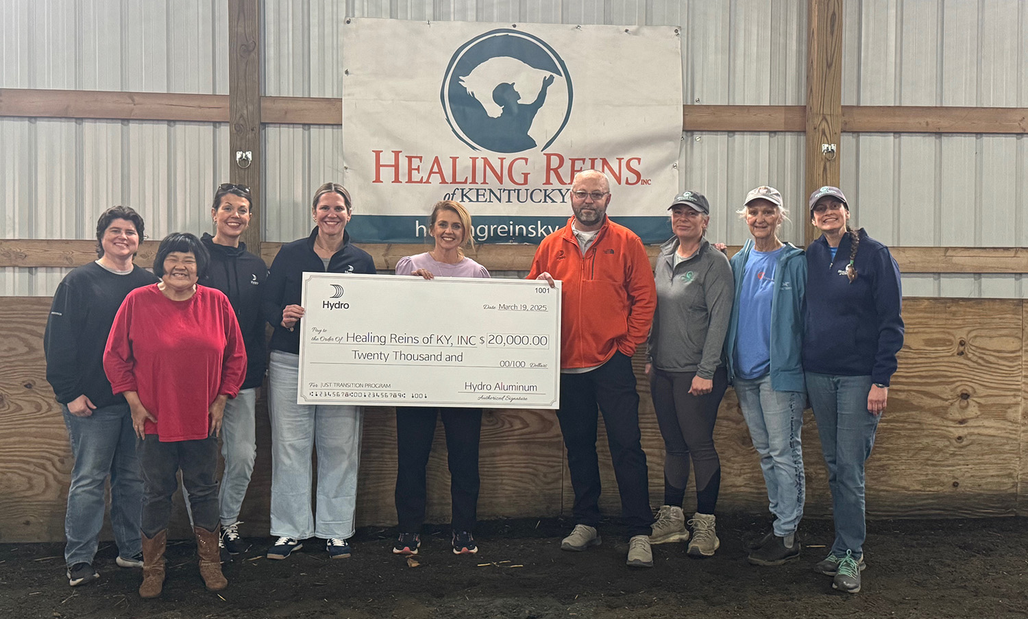 a group of people holding a check