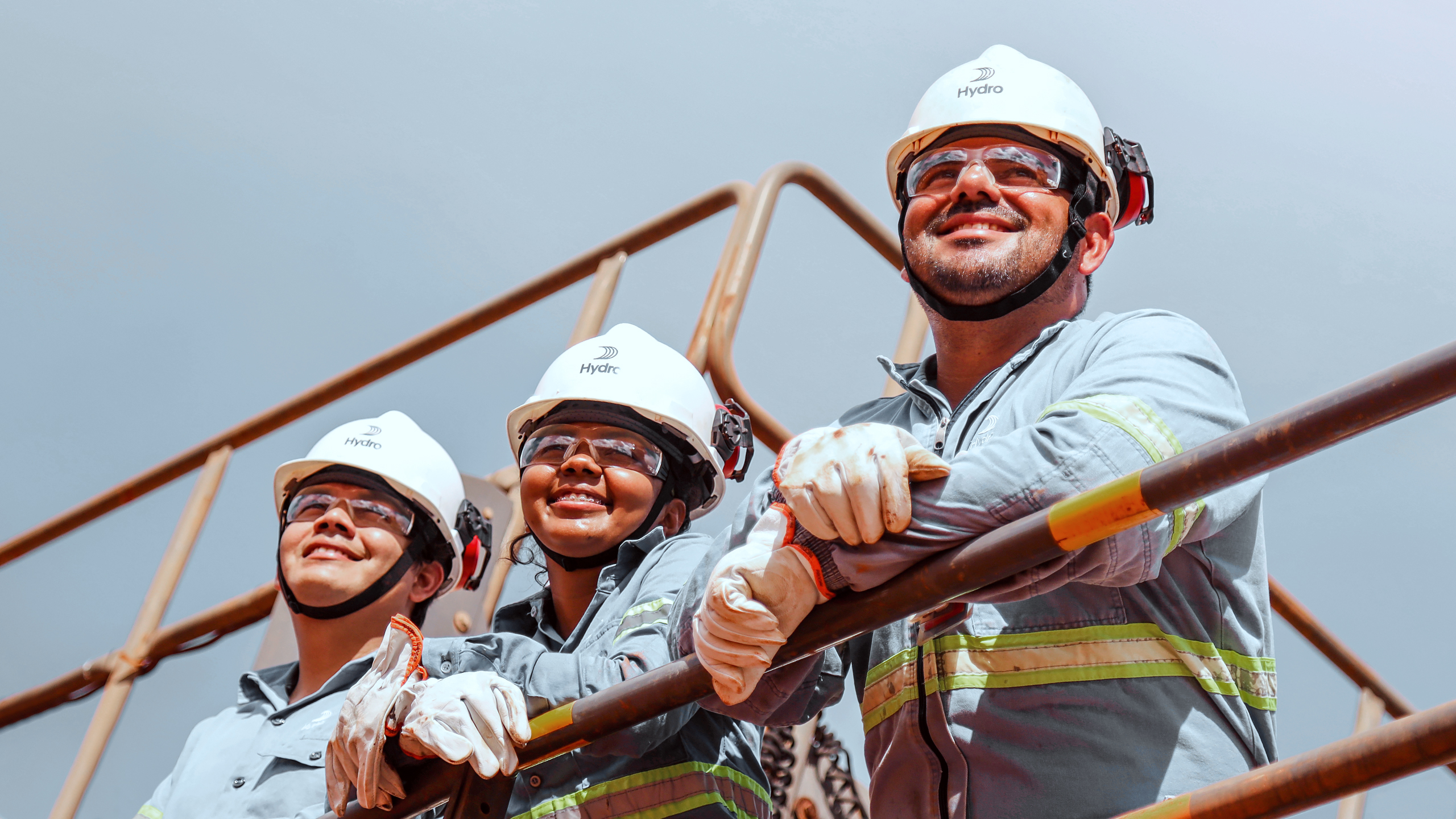 a group of people wearing safety vests and helmets