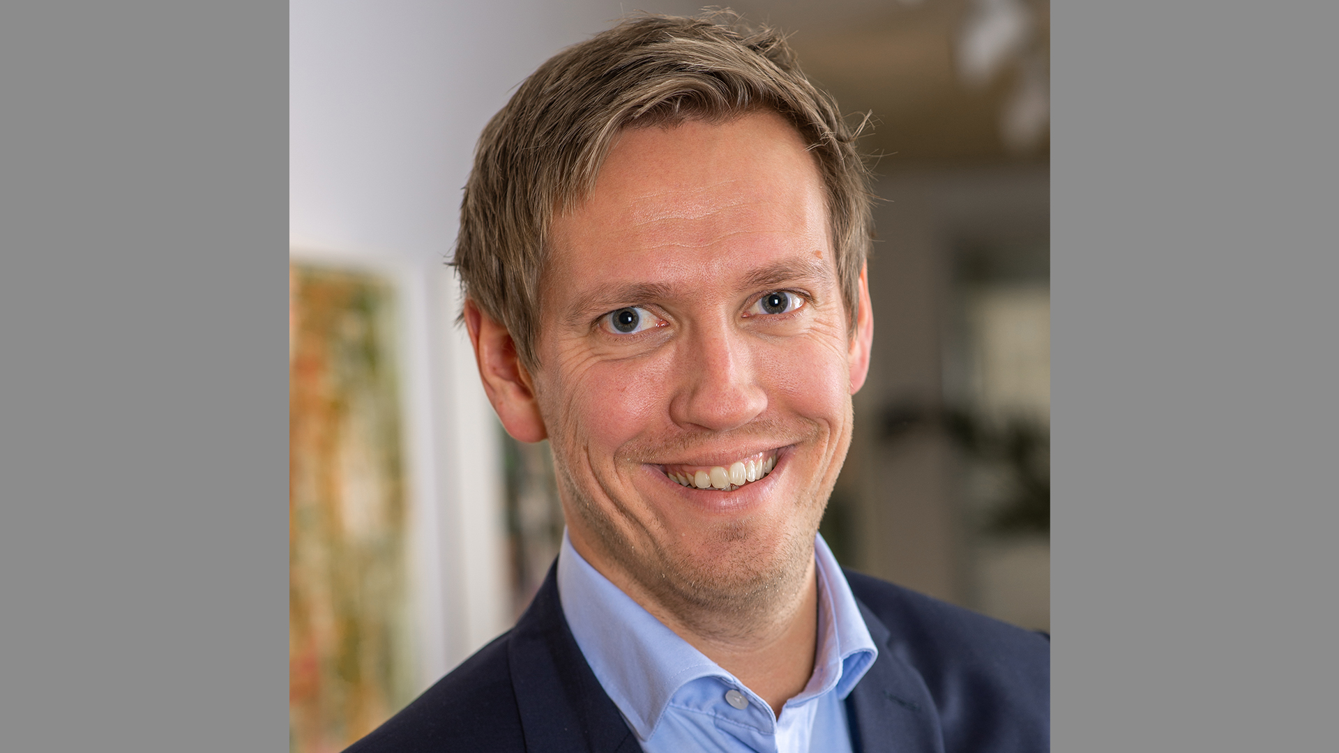 a man smiling at the camera