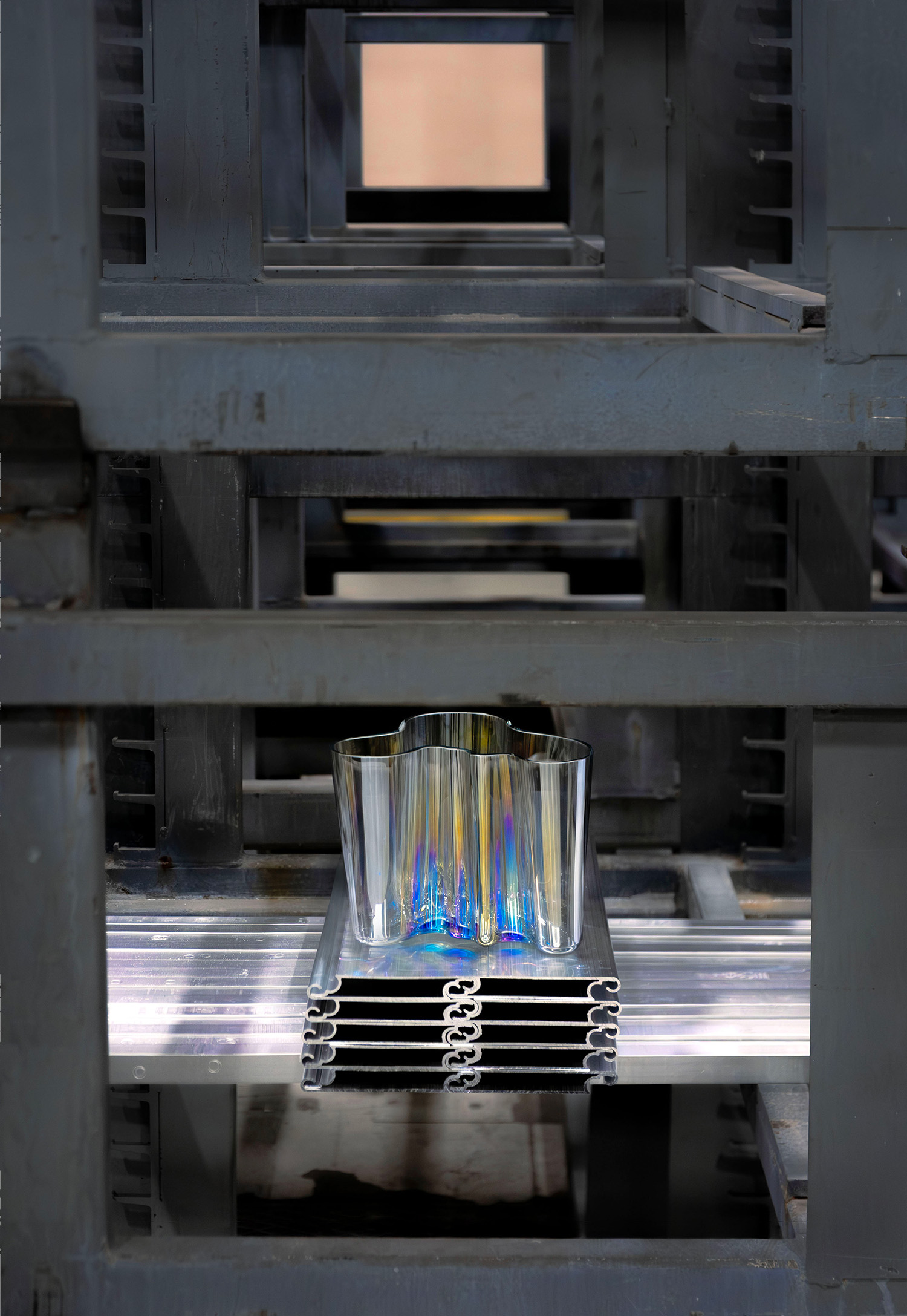 a aluminium vase on a metal shelf