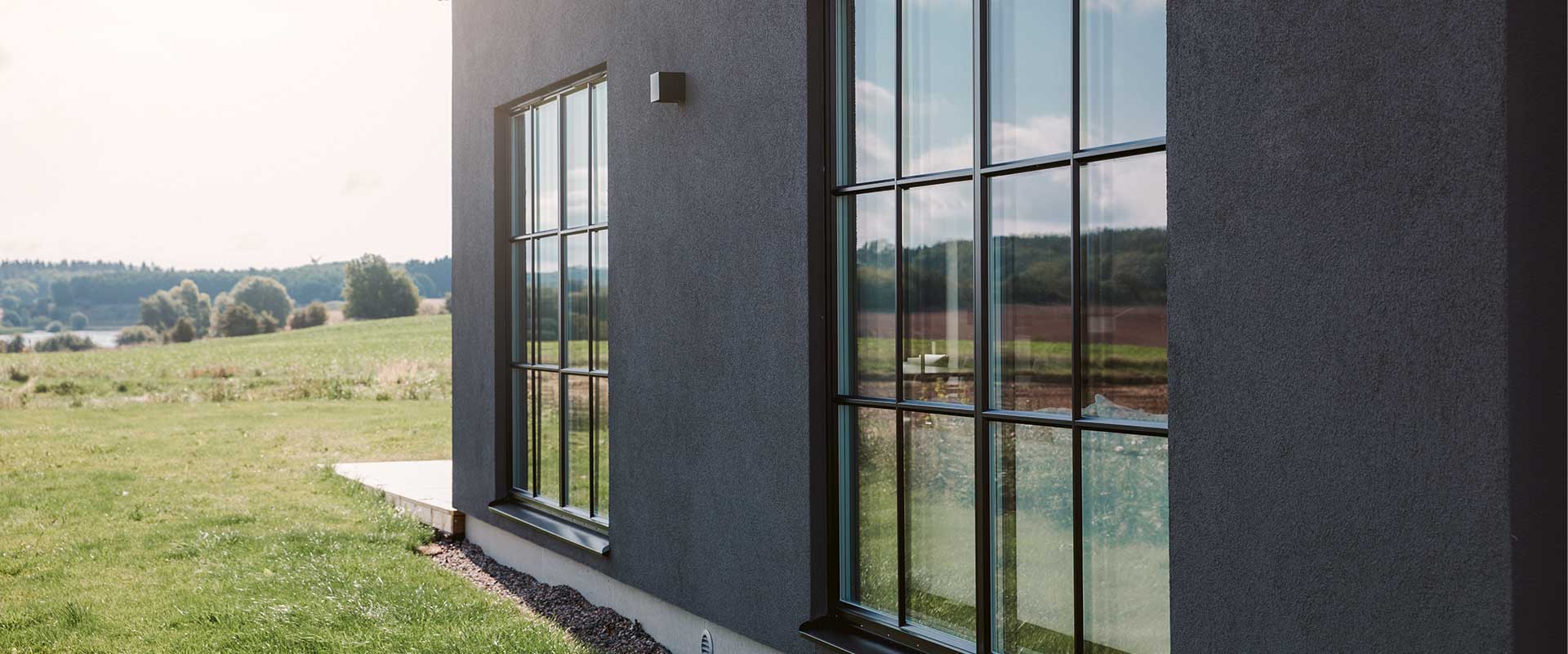 a building with windows and grass