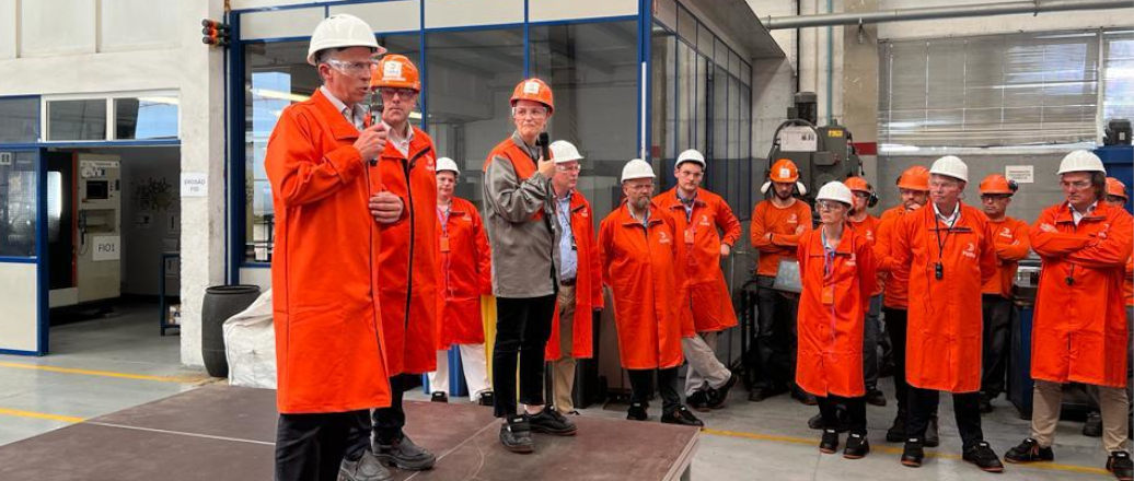 a group of people wearing orange jackets