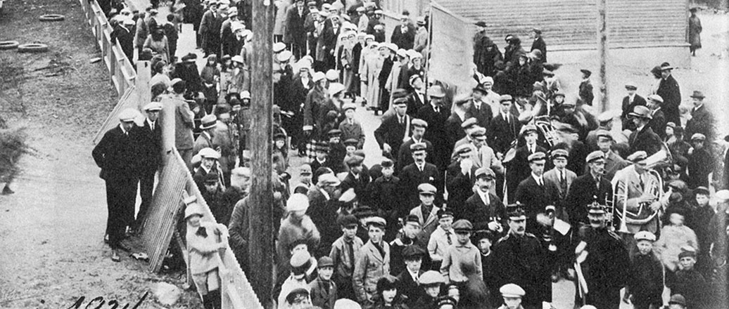 People marching with band and banner