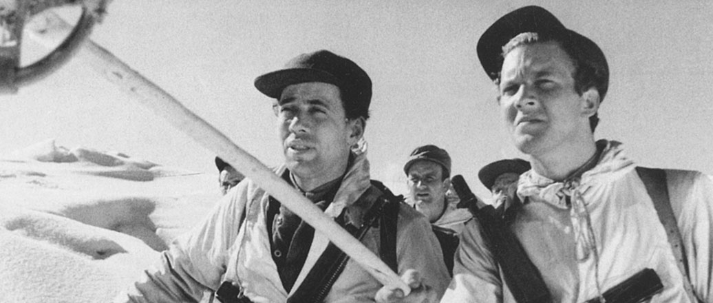 men in white ski suits, in snow