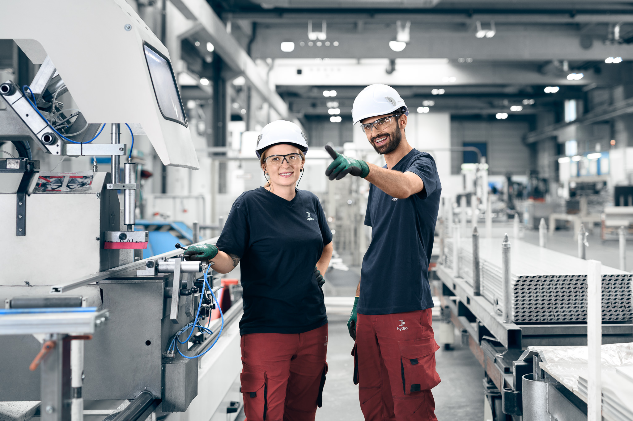 a man and woman wearing hard hats