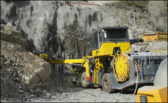a yellow bulldozer in a rocky area
