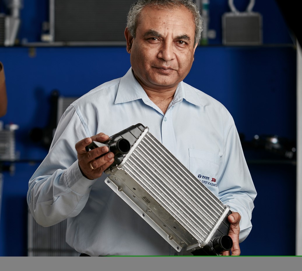 Ravi Chidambar holding a heat exchanger