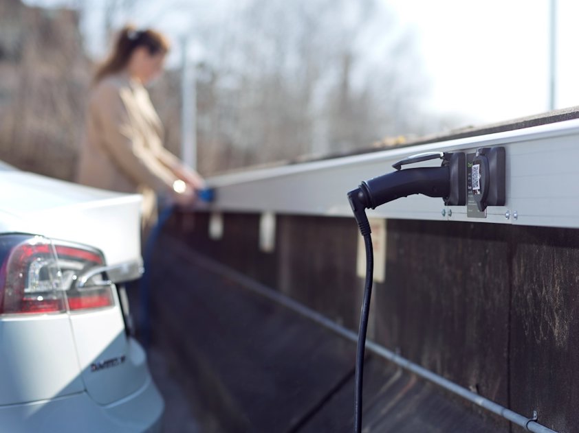 a person standing next to a car